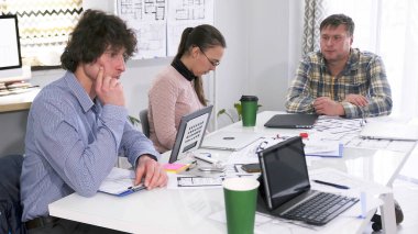 Görevden alınmayı bekliyor. Bir grup genç bir konferans odasında bir masada oturuyor ve ciddi olarak bir şeyler düşünüyorlar. Sahne odaklandı. Takım çalışması ve beyin fırtınası..