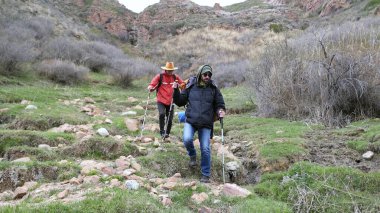 Dağlardan iki turist geliyor. İki adam çölde kayaların ve çimlerin üzerinde yürüyorlar. Seyahat, macera ve özgürlük