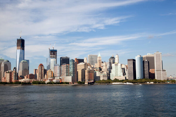 The view of Lower Manhattan skyline by Hudson River in late afternoon (New York City).