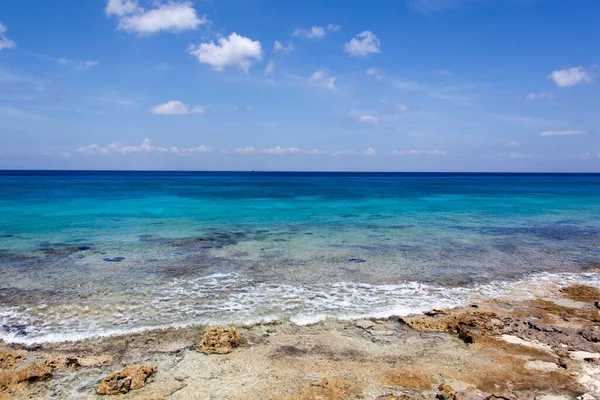 The scenic view of turquoise color sea and a rocky shore in San Miguel resort town on Cozumel island (Mexico).