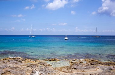 Cozumel Adası 'nda (Meksika) kayalık sahil yakınında farklı türde tekneler.).