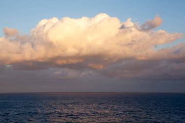 The scenic view of an orange color cloud during the sunset (Nassau, Bahamas).