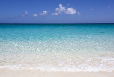 The scenic view of an empty Cabbage Beach colorful transparent water on Paradise island (Bahamas). 