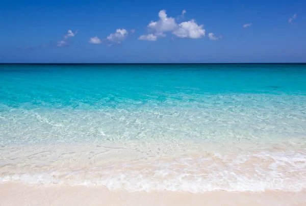 The scenic view of an empty Cabbage Beach colorful transparent water on Paradise island (Bahamas). 