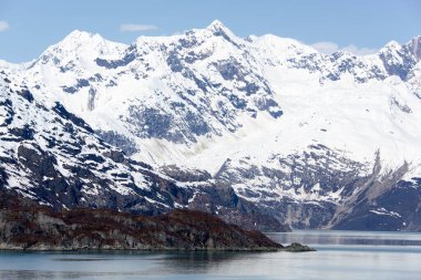 The scenic view of snowy mountains on May in Glacier Bay national park (Alaska).