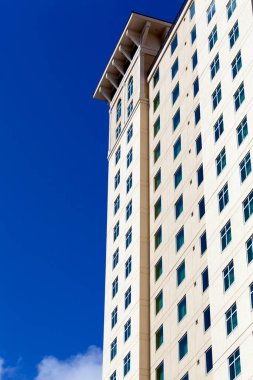 The abstract view of an apartment building with a blue sky in a background in Tampa city (Florida).