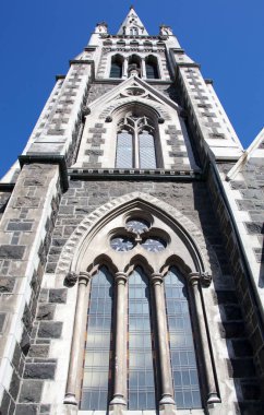 The tall gothic revival style church spire in Dunedin city (New Zealand).