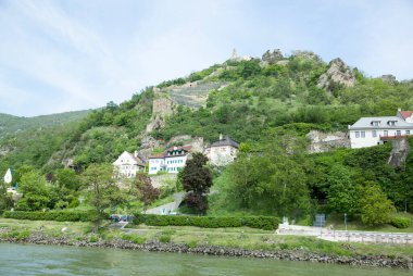 The springtime view of historic Durnstein town by Danube River with a castle ruins on a hill top in Wachau valley (Austria).