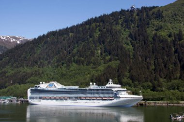 The view of moored large cruse liner and its reflections in Juneau town (Alaska).