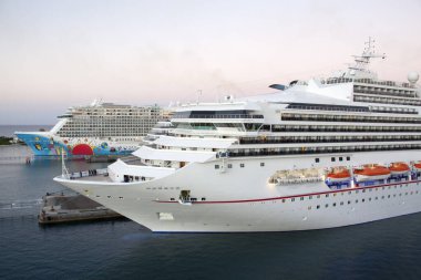 The view of large cruise ships moored in Nassau city port after the sunset (Bahamas).