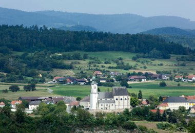 The summertime view of Emmersdorf an der Donau town with a historic church in Wachau valley (Austria).