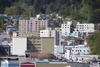 The springtime view of different buildings surrounded by wilderness in Juneau downtown, the capital of Alaska.