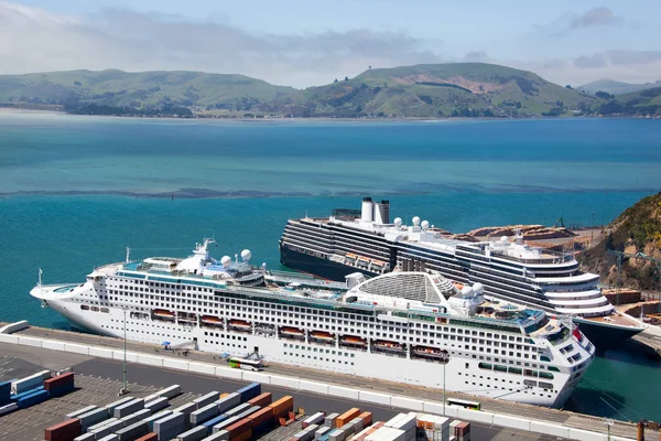 The aerial view of two large cruise ships moored in Port Chalmers town port (New Zealand).