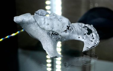 Human hip bone prototype printed on 3D printed from polyamide powder close-up. 3D model created by additive 3d printing technology. Multi Jet Fusion MJF. Concept new modern hi-technology 3d printing
