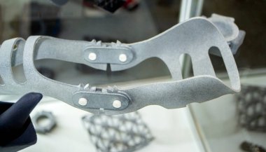 Gray orthopedic plastic prosthesis printed on powder 3D printer for cubit hand. Orthopedic gypsum helmet closeup. Multi Jet Fusion MJF 3D printing technology. New modern progressive additive technolog