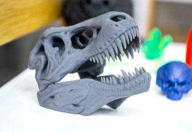 Model dinosaur skull printed on 3d printer. Object photopolymer printed on stereolithography 3D printer. Technology of liquid photopolymerization under UV light. New additive 3D printing technology clipart