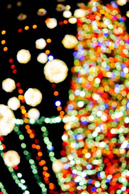 New Years Christmas tree decorated with luminous multi-colored garlands and illumination at night. Christmas tree with flashing lights. Blurred background. New Year Christmas holidays.