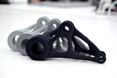 Black white gray models printed on 3D printer in laboratory office. Objects printed on 3D printer from plastic. Prototypes made on 3d printer. Concept new modern printing technology. Multi Jet Fusion