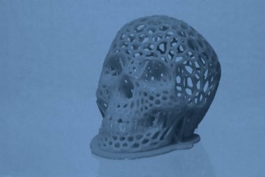 3D printed human skull prototype printed of red plastic close-up.