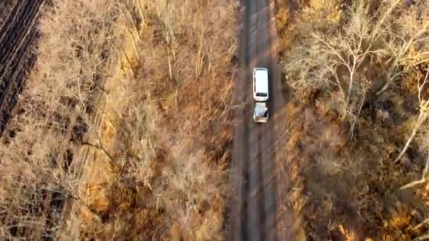 White Car Trailer Driving Dirt Country Road Trees Leaves Autumn — Stockvideo