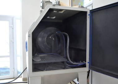 Inside Shot blasting machine. Open machine for Shot blasting of objects. Industrial machine