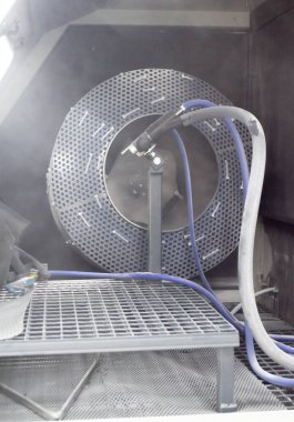 Inside Shot blasting machine. Open machine for Shot blasting of objects. Industrial machine