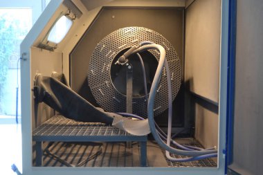 Inside Shot blasting machine. Open machine for Shot blasting of objects. Industrial machine, rubber gloves