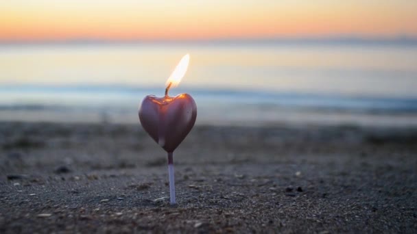 Heart Shaped Candle Burning Sand Beach Sea Waves Sunset Dawn — Wideo stockowe