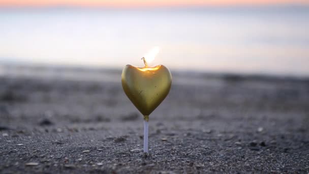 Heart Shaped Candle Burning Sand Beach Sea Waves Sunset Dawn — Stock Video