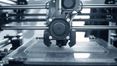 3D yazıcı. 3D yazıcı yakın plan yazdırıyor. Erimiş plastik Extruder 'dan akıyor ve prototip modelini oluşturuyor. 3D yazıcı için yeni modern katkı teknolojileri. Modelleme için elektronik aygıt.