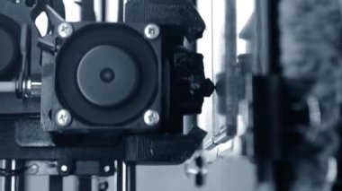 3D yazıcı. 3D yazıcı yakın plan yazdırıyor. Erimiş plastik Extruder 'dan akıyor ve prototip modelini oluşturuyor. 3D yazıcı için yeni modern katkı teknolojileri. Modellik için elektronik cihaz. Dikey