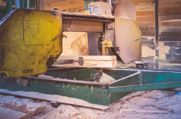 stock image Sawmill. Process of machining logs in equipment sawmill machine saw saws the tree trunk on the plank boards. Wood sawdust work sawing timber wood wooden woodworking