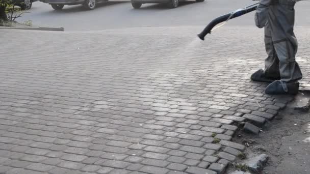 Védőruhás Férfi Fertőtlenítő Oldatot Permetez Járdán Városban Persona Fertőtlenítő Spray — Stock videók