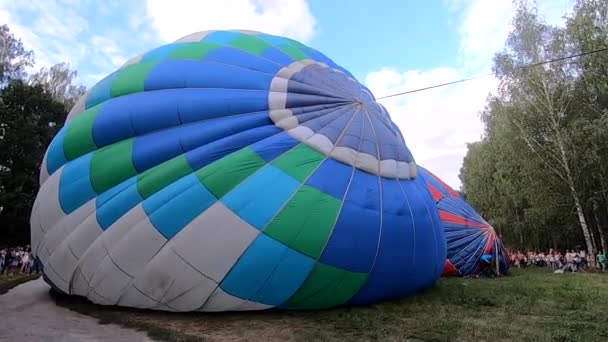 Bila Tserkva ウクライナ 2021年8月24日 気球が地上に横たわっている バルーンフェスティバルで空気で膨らんだ大きな青い風船 気球充填空気 バルーニングだ レジャーエンターテイメント観光 — ストック動画