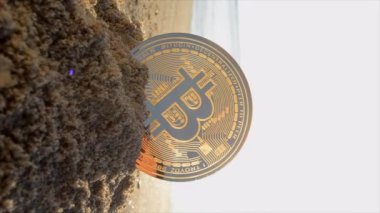 Bitcoin BTC coin in sand on sandy beach of sea coast on a sunny morning close-up. Concept bitcoin money cryptocurrency finance cryptocurrencies crypto bit coin digital web 3.0 cryptography Vertical