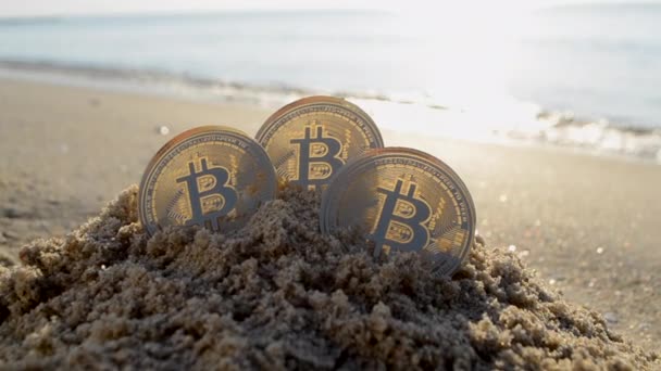 Three Bitcoin Btc Coins Sand Sandy Beach Sea Coast Sunny — Αρχείο Βίντεο