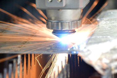 Metal lazer kesimi. Lazer metalin yakın plan kesimiyle metal levha kesimi. Fabrikada metal kesmek için endüstriyel ekipman makinesi. Kıvılcımlar saçar. Metal işleri üretim arka planı