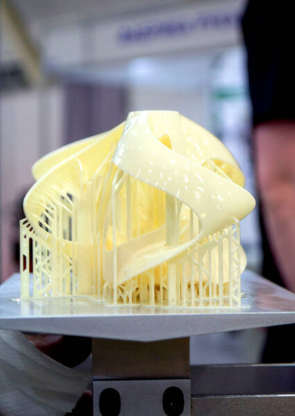 Printed models on 3D printer close-up. Objects printed on photopolymer sla 3D printer from liquid photopolymer resins on printing platform. Modern progressive additive technology. 3D printer printing