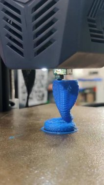 3D yazıcı yakın planda çalışıyor. Erimiş mavi plastikten 3D yazıcı baskısı modeli. 3D yazıcı yazdırma nesnesi. Yeni modern prototip teknolojileri. Katkı sağlayan ileri teknoloji ürünü bir teknoloji. Dikey