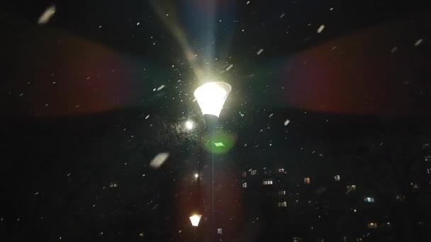 Spadający Śnieg Świecąca Latarnia Świecące Światło Oknach Budynków Mieszkalnych Mieście — Wideo stockowe