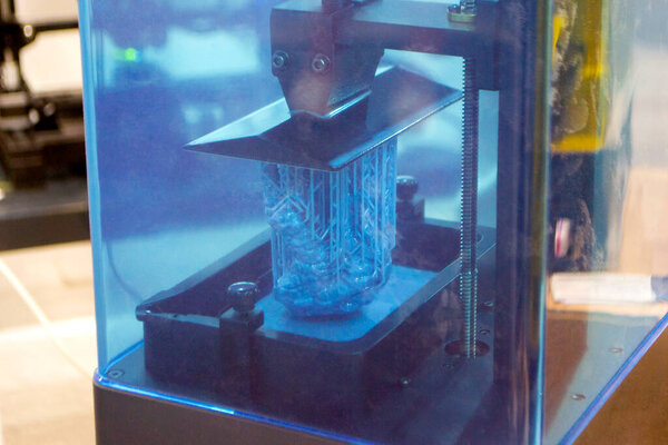 Process SLA 3D printing. Process printing on 3D printer by SLA printing technology. 3D printed object from resin polymerization. Object created on 3D printer from hardened resin. Printing technology