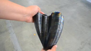 Elinde vazo tutan kişi, metalden 3D yazıcı tarafından basılmış. Katkı maddesi üretim çözeltisi. Metal iplikten 3Dprinter 'da nesne oluşturuldu. 3D Metal Yazdırma. Metal katkı maddesi üretimi