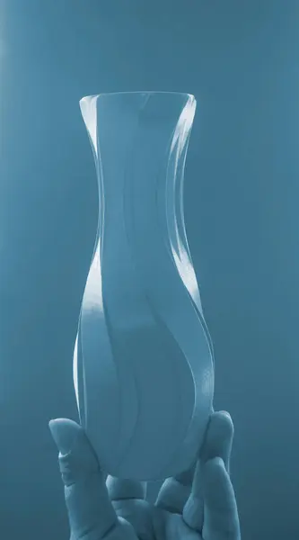 stock image Person holding vase model, printed on 3D printer, against blue wall. Three-dimensional model printed on 3D printer from molten plastic. Concept 3D Printing. FDM 3D Printing technology