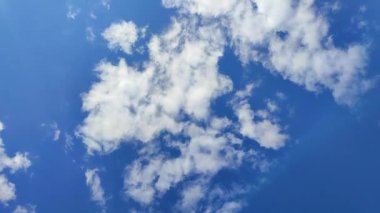 Güneşli bir günde mavi gökyüzünde hızlı hareket eden beyaz bulut. Gökyüzünde hızla hareket eden ve değişen bulut. Gökyüzünde bulut. Alt manzara. Atmosfer. Hava durumu. Doğa arkaplanı. Doğal arkaplan