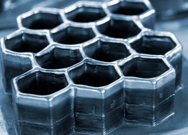 Masadaki erimiş metal filamanından üç boyutlu yazıcıya basılmış nesneler. Metalden 3D yazıcı tarafından basılan nesne. Katkı maddesi üretim çözeltisi. Eriyen metal ipliğinden 3D yazıcıda nesne oluşturuldu