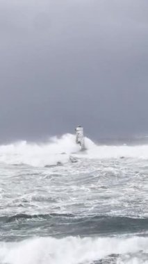 the lighthouse of the mangiabarche in calasetta, in southern sardinia, submerged by the waves of the stormy sea