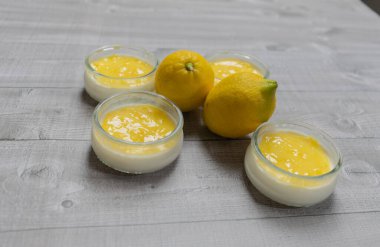 Delicious lemon curd, fresh fruit on a gray background