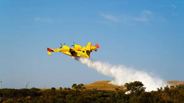 stock image Carbonia, Italy, august 8 2024: A Canadair, amphibious water bomber of the firefighters engaged in putting out a fire