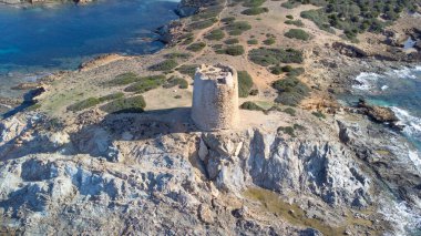 Piscinni or Pisxinni beach and Spanish tower in Teulada in southern Sardini clipart