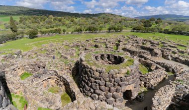 Ancient megalithic edifice of nuragic civilization, dating back to the bronze age, stands majestically against a vibrant sky clipart